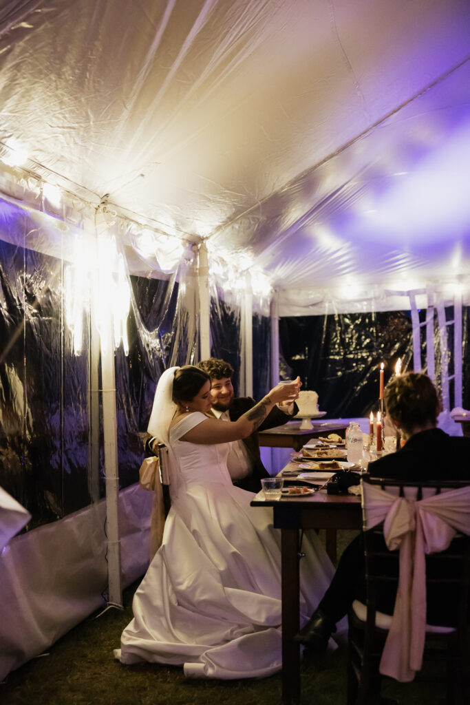 Bride and groom in a decorated wedding tent