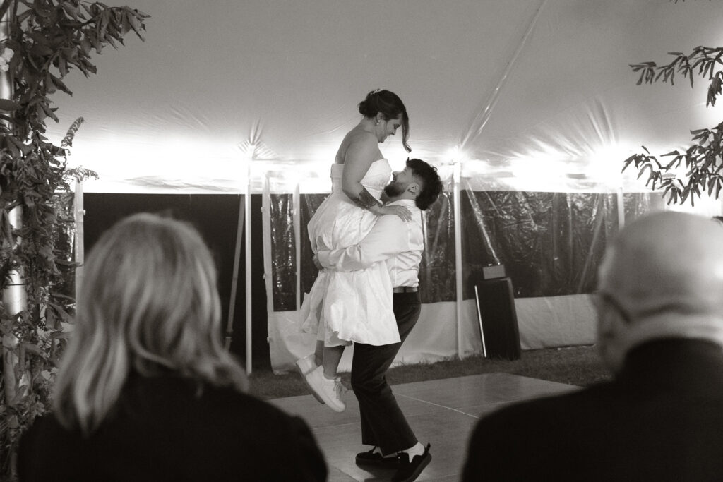 Bride and groom dancing under a tent