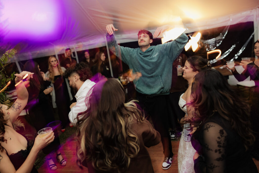 People dancing energetically at a lively indoor party