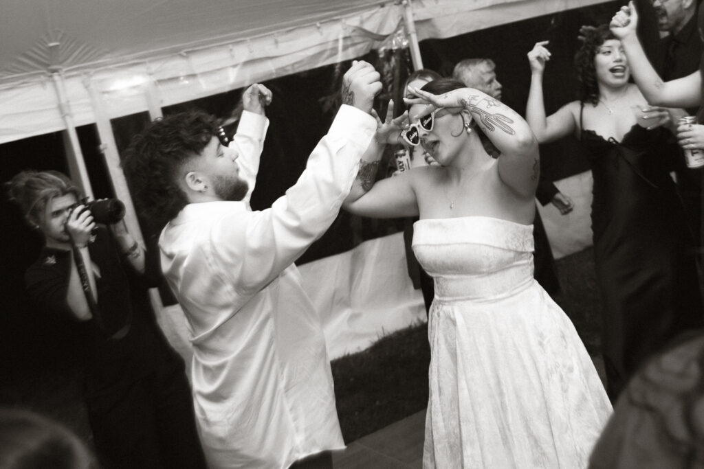 Black and white photo of a lively celebration with people dancing.