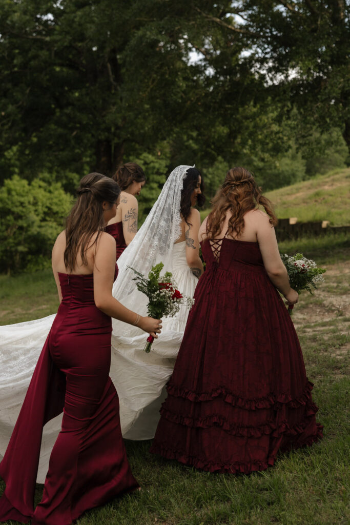 Bride and bridesmaids walking outdoors in elegant dresses