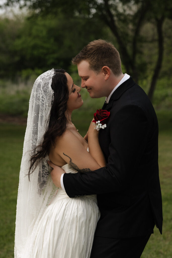 Bride and groom embracing outdoors