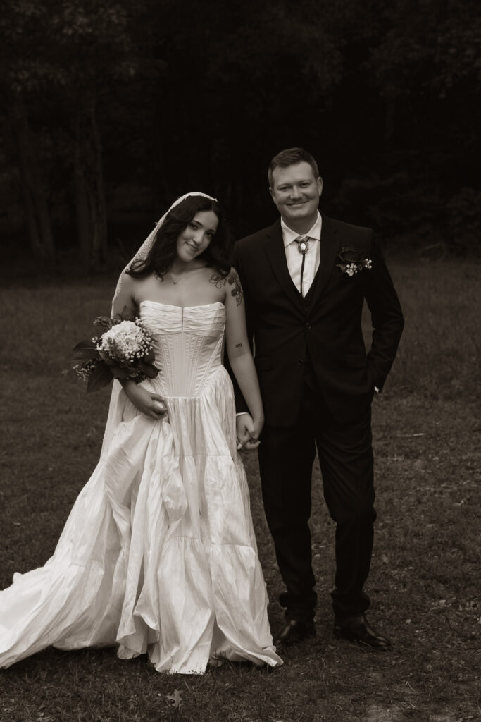 Bride and groom holding hands in an outdoor setting