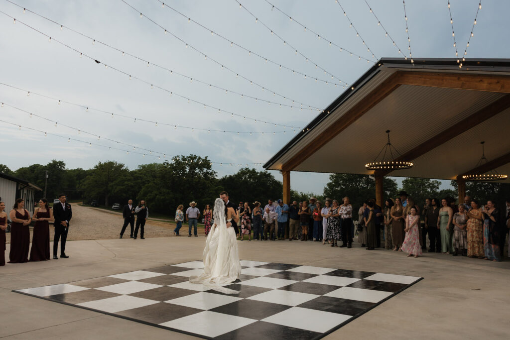 Outdoor wedding dance on a checkered floor