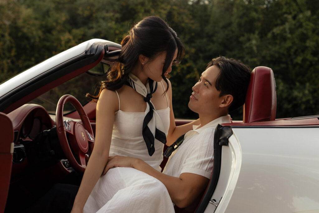 Couple in convertible car during engagement photo shoot
