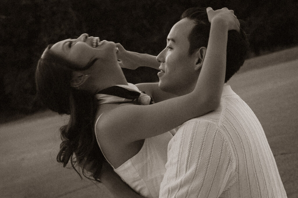 Couple embracing and laughing in vintage style photograph