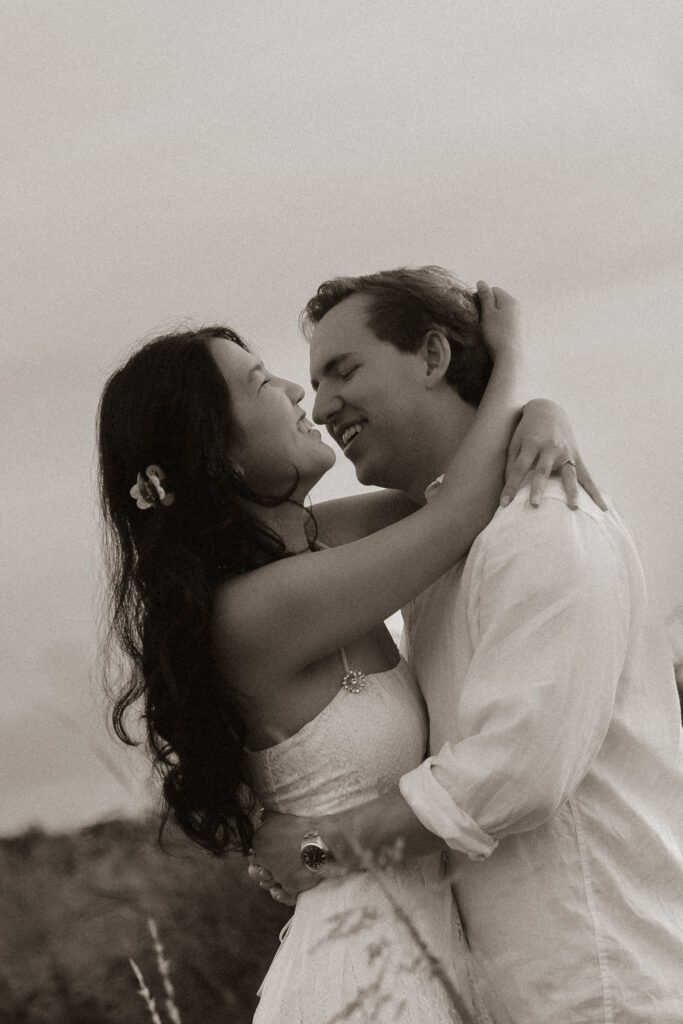 Couple embracing at sunrise near a lake