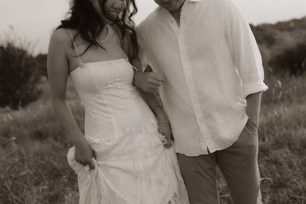 Couple embracing during lakeside engagement session
